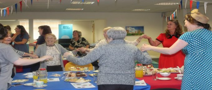 people dancing around the table at disabled living 1940's tea dance