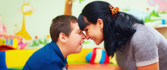 mum smiling at young boy with cerebral palsy