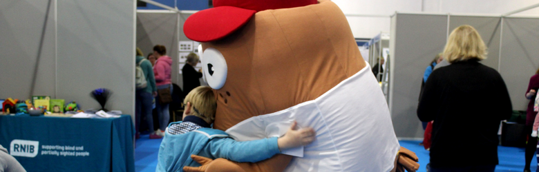 child giving mascot a hug