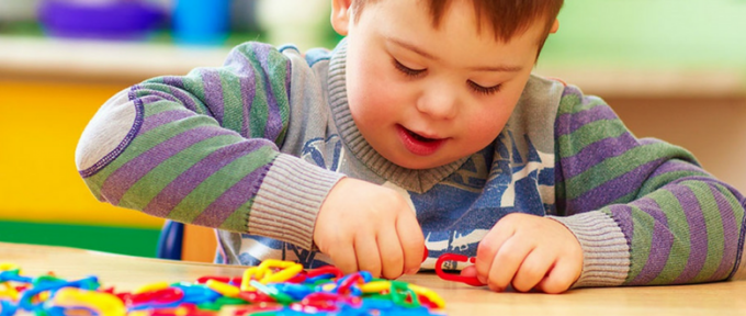 cerebral palsy young boy playing with puzzle