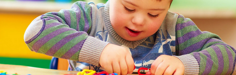 cerebral palsy young boy playing with puzzle