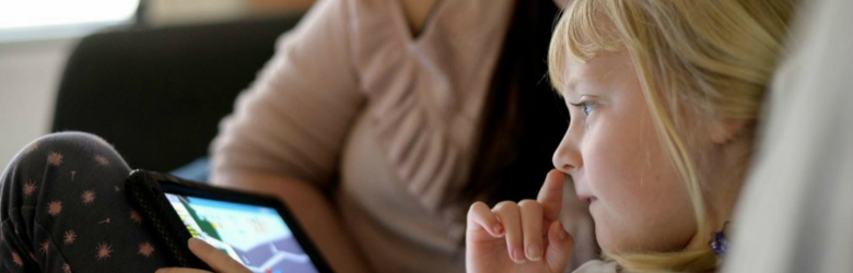 little girl looking at tablet