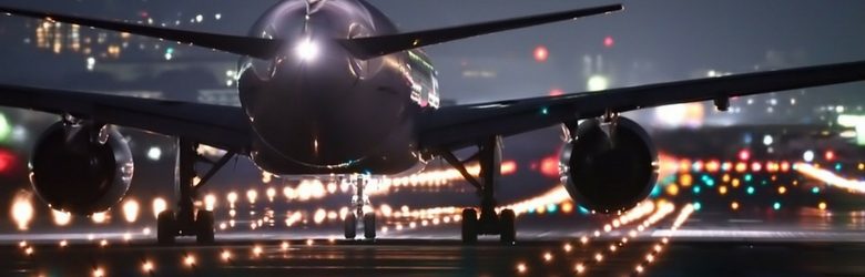 aeroplane landing at airport at night