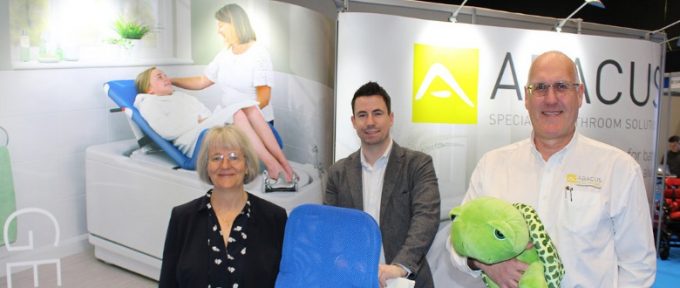 three abacus representatives stood at their exhibition stand