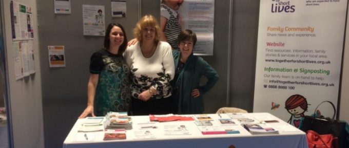 together for short lives representatives stood at their exhibition stand