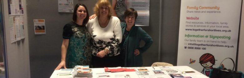 together for short lives representatives stood at their exhibition stand