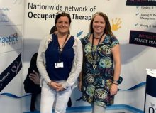 two members of the ot practice stood at their stand
