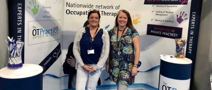 two members of the ot practice stood at their stand