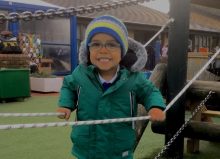 young boy smiling in adventure playground