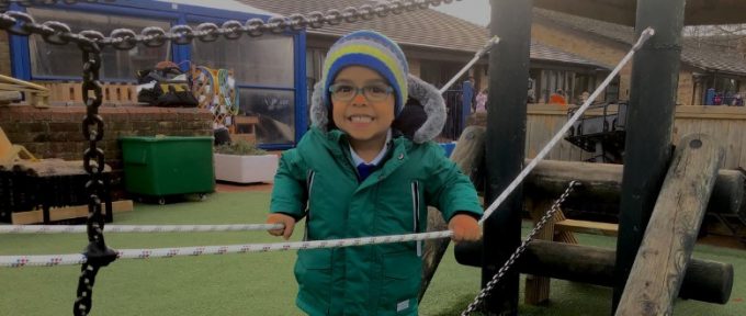 young boy smiling in adventure playground