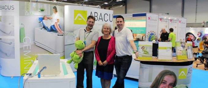 kate with her colleagues stood on abacus stand