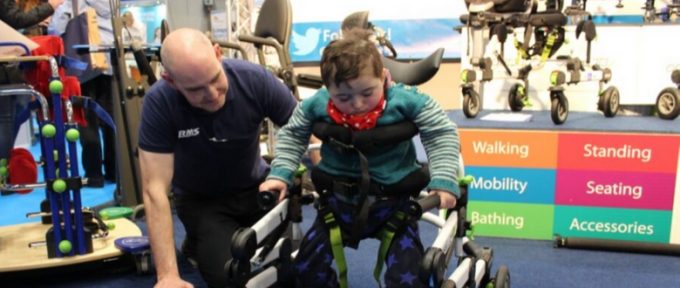 young boy trying out equipment in exhibition hall