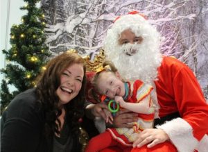 mother child and father Christmas smiling
