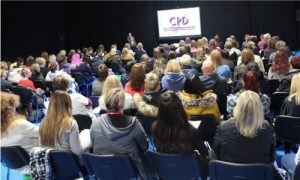 large audience seated in seminar room