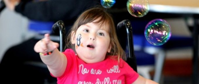 girl in wheelchair with bubbles