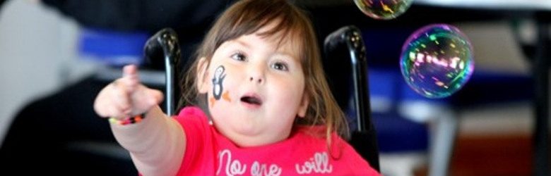 girl in wheelchair with bubbles