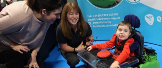 child smiling using equipment at event