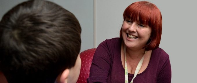 member of staff looking at child