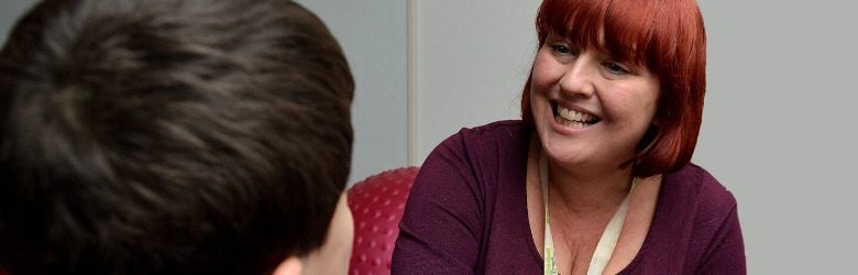 member of staff looking at child