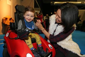 child in wheelchair with mum
