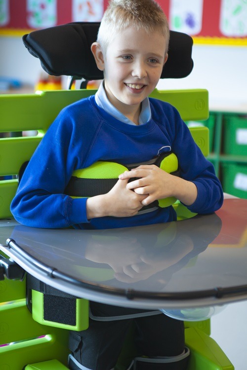 uoung boy wearing school uniform in supine stander