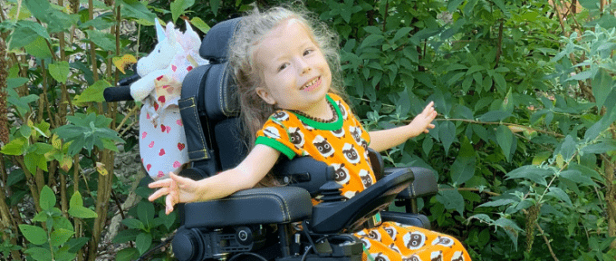 little girl in one of Precision Rehab's Powerchairs