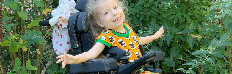 little girl in one of Precision Rehab's Powerchairs