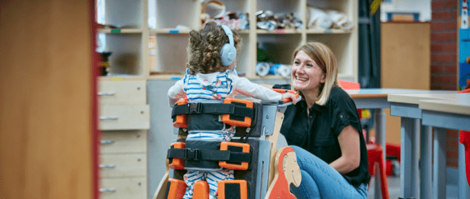 woman smiling and child using Jenx equipment