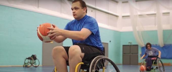 Man in wheelchair playing basketball