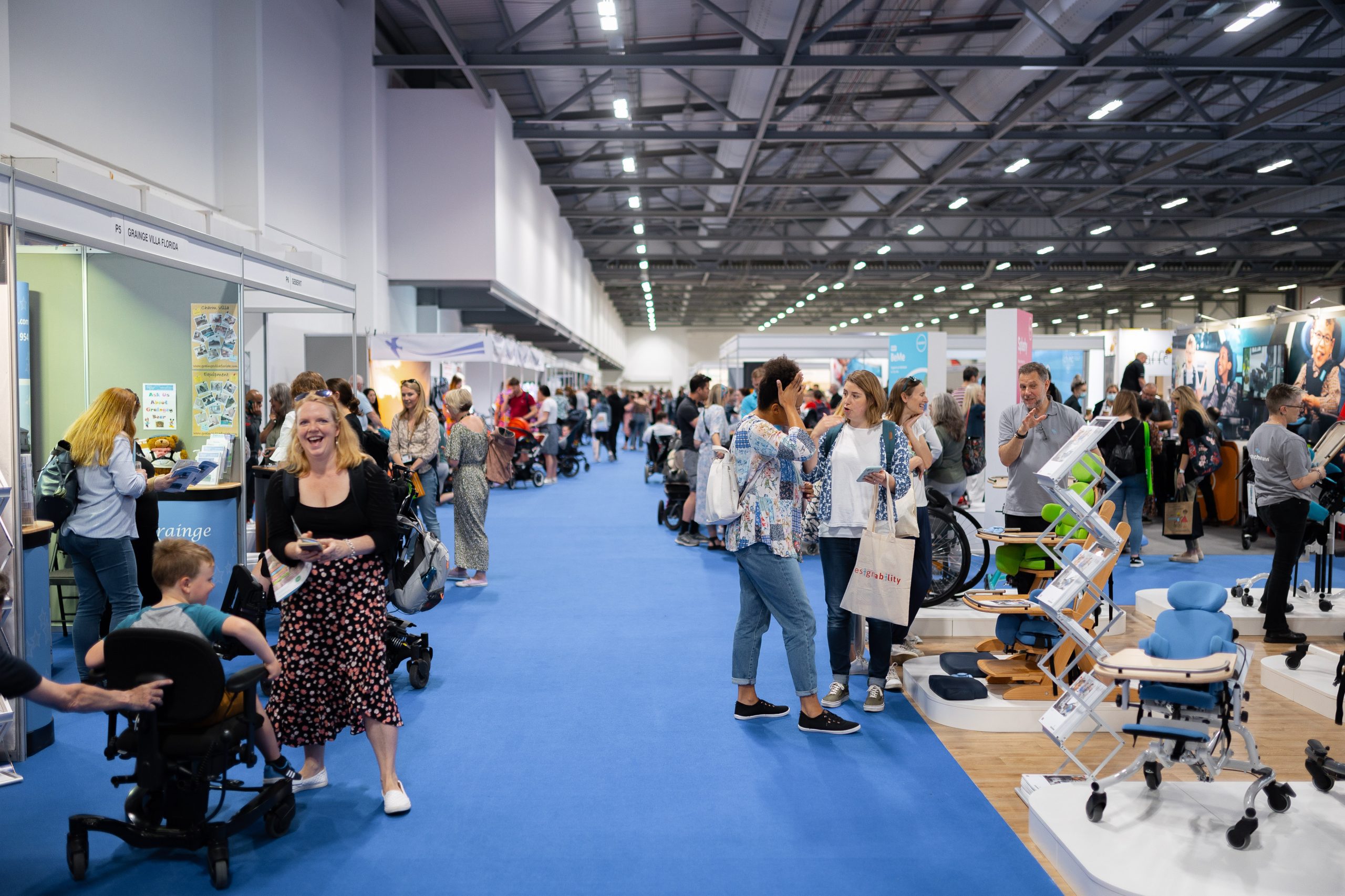 Busy venue space showing visitors discovering different exhibitors