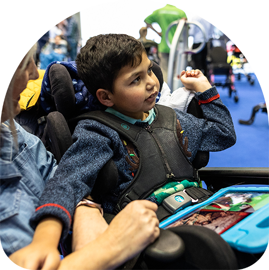 Boy playing game on a tablet sat in wheelchair