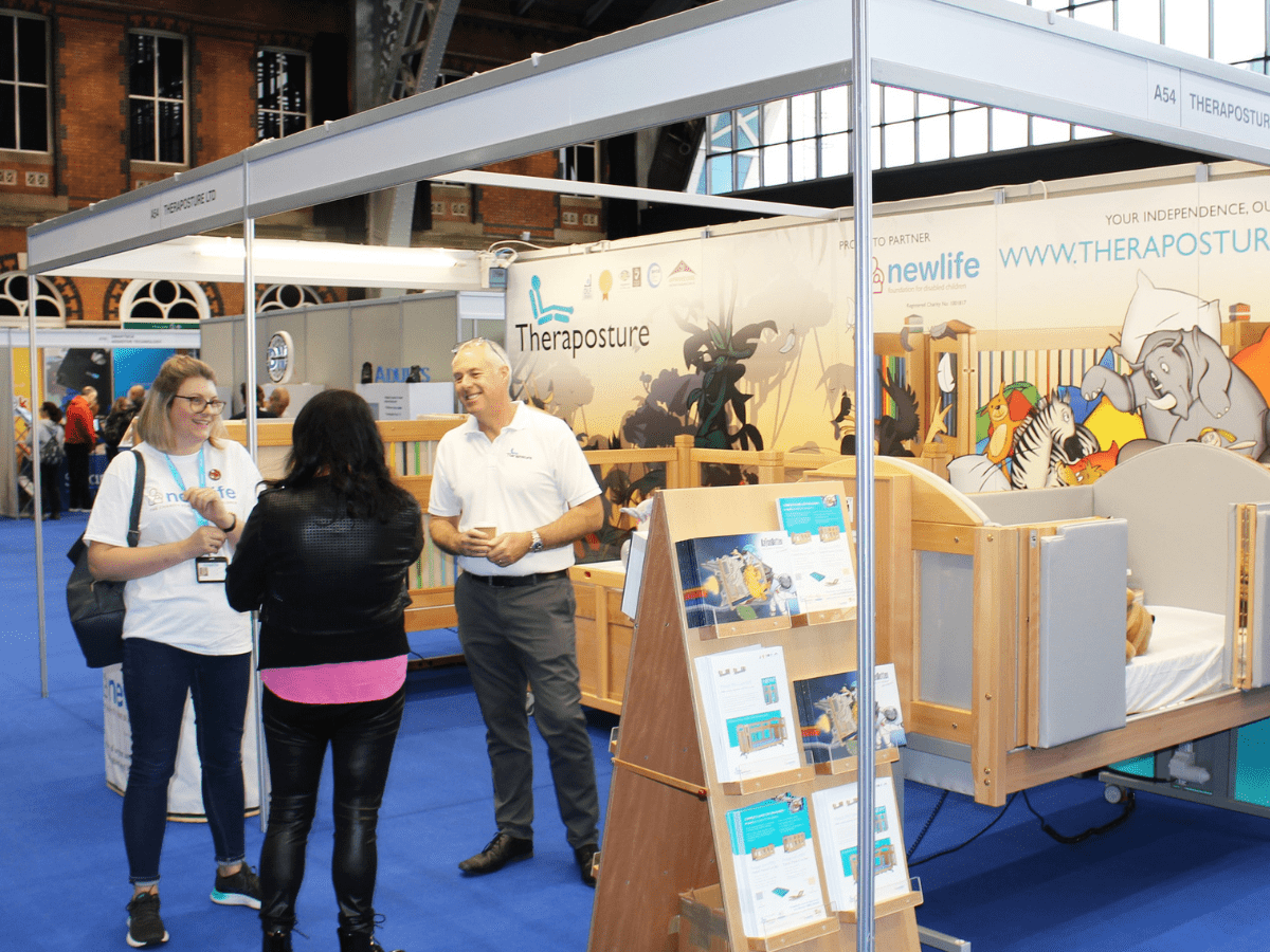 an image of theraposture speaking with members of the public at their stand
